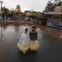 China, Hong Kong, 17.11.2011 | A chuva incomoda mas nao impede esta duas meninas de passearem pela Disneyland de Hong Kong, numa altura em que o parque se expande e estreia uma área Toy Story. 