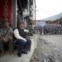 Dois exilados tibetanos, à porta de uma escola tibetana em Katmandu, com agentes da polícia ao fundo. Objectivo: impedir a celebração do aniversário do líder espiritual do Tibete, o Dalai Lama (a 6 de Julho), receando protestos anti-China.