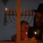 Israel, 20.12.2011 | Um judeu ultra-ortodoxo segura o filho enquanto acende uma vela para marcar o Hanukkah (o festival das luzes, de 20 a 28 de Dezembro), uma das mais importantes celebrações judaicas. 