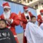 China, Handan. Voluntários vestidos de Pai Natal cortam o cabelo de rapazes de um centro de apoio