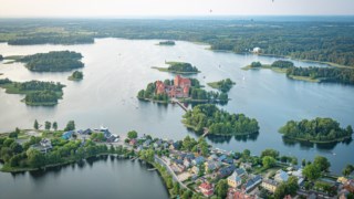 Hot Air Balloon Flight over Trakai. Medieval castle of Trakai, Vilnius, Lithuania, Eastern Europe, surrounded by beautiful islands, lakes, forests, wilderness, nature in summer at sunset, aerial view