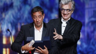 Director Miguel Gomes receives the Best Director award for the film "Grand Tour" from Wim Wenders, during the closing ceremony of the 77th Cannes Film Festival in Cannes, France, May 25, 2024. REUTERS/Stephane Mahe�