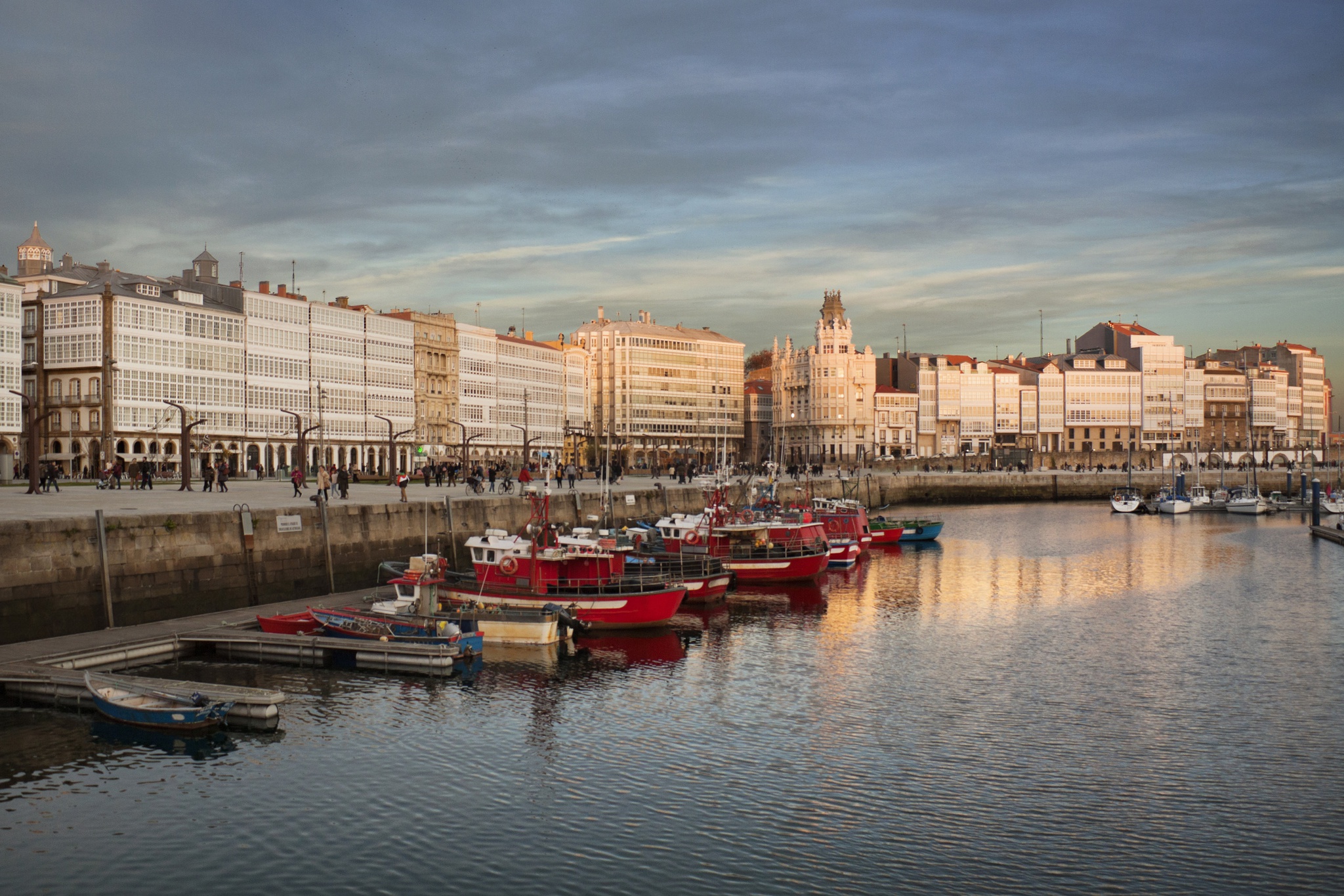 Panoramic view of A Coruna with the glass-fronted balconies on background and the fishing harbour in the front; A Coruña, Galicia, Spain.