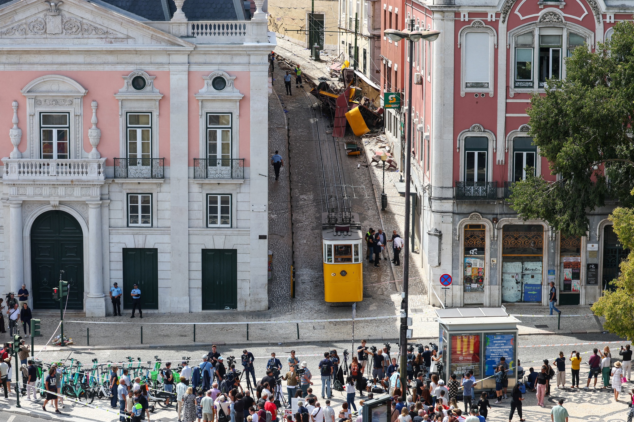 People gather near the site of the accident after Gloria funicular railway car, a popular tourist attraction, derailed and crashed, resulting in multiple casualties, according to authorities, in Lisbon, Portugal, September 4, 2025. REUTERS/Pedro Nunes