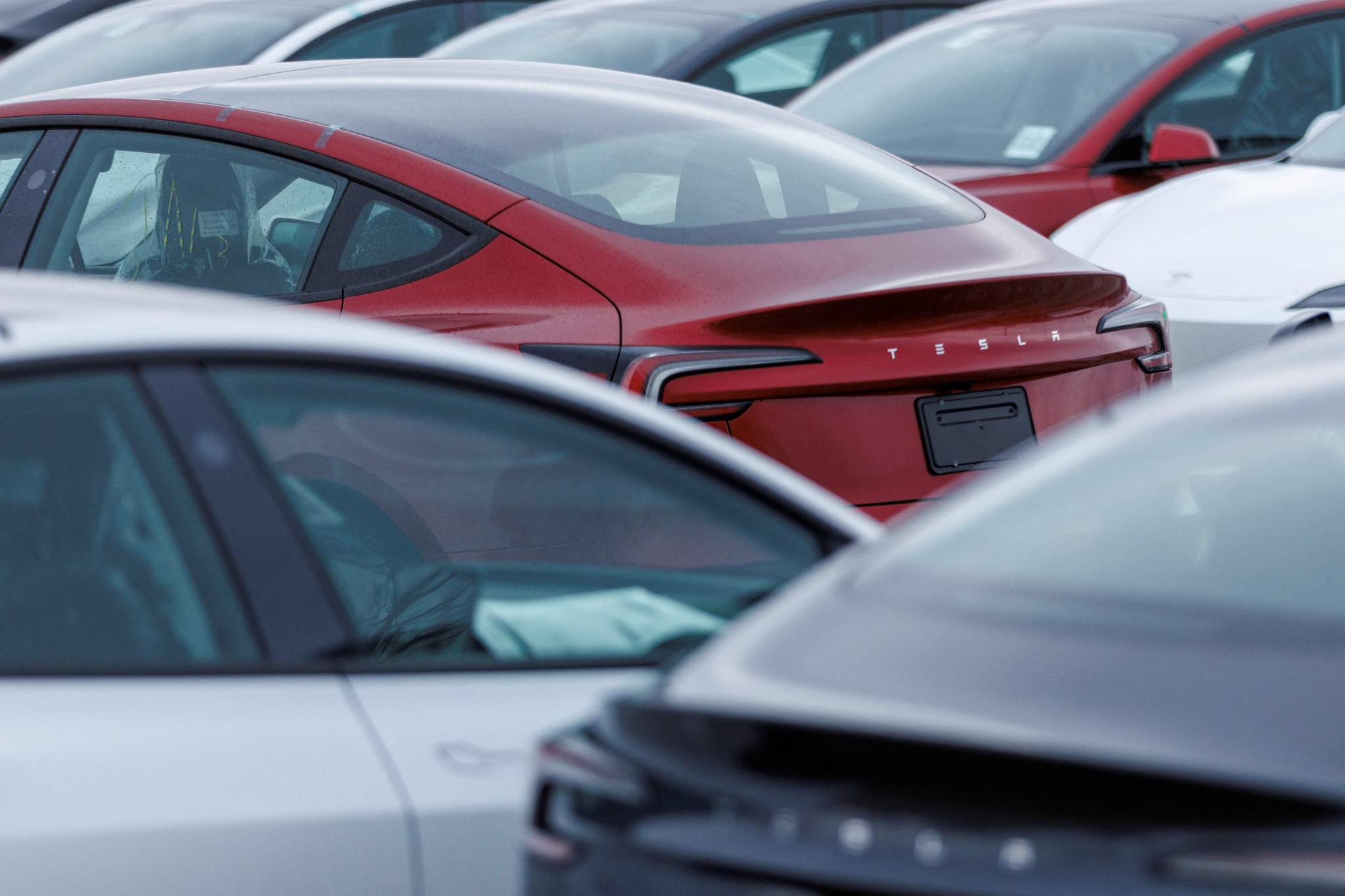 Tesla cars are parked outside a Tesla showroom as police investigates a report of vandalism to dozens of vehicles in Hamilton, Ontario, Canada March 20, 2025. REUTERS/Carlos Osorio