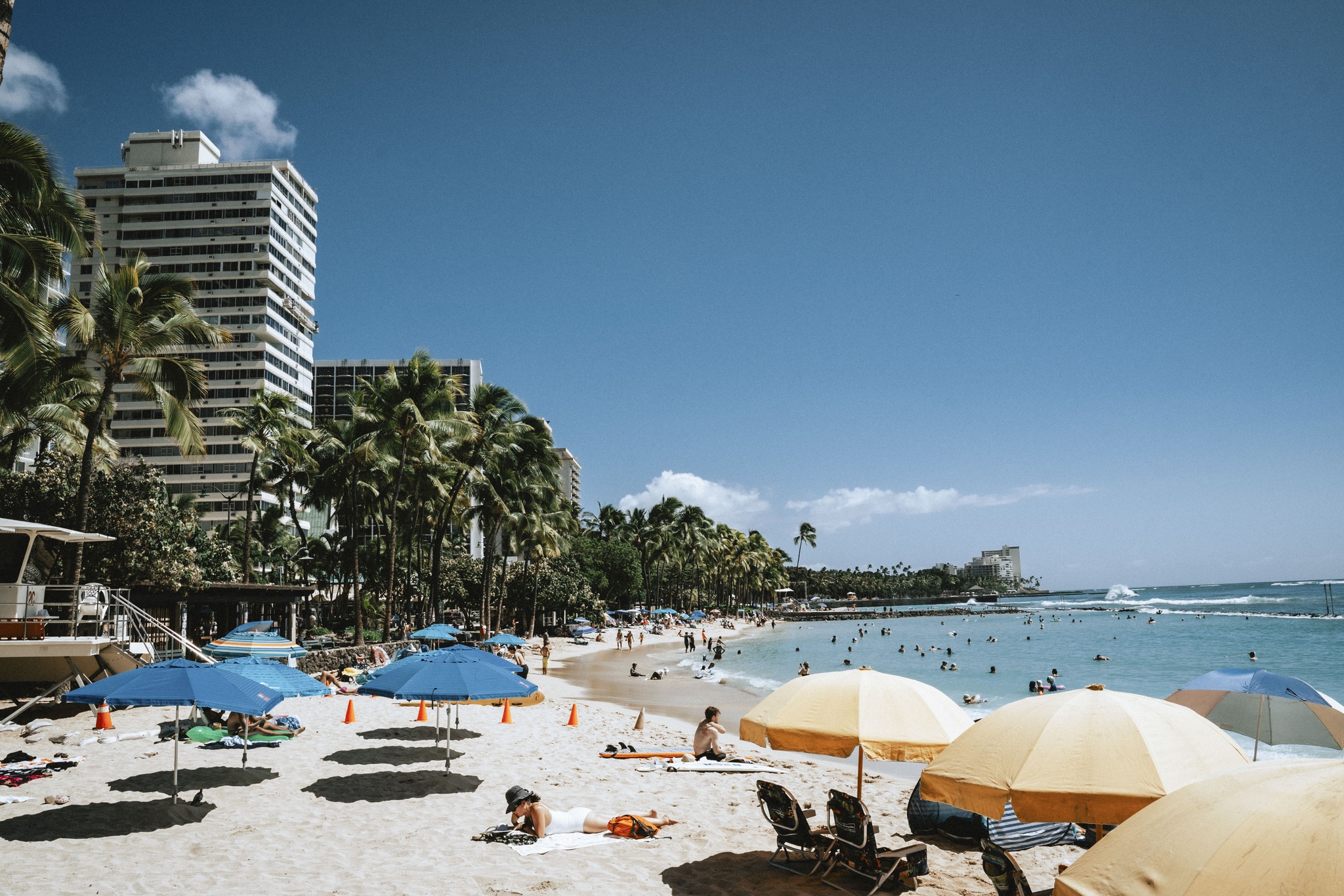 HONOLULU, HI - SEPTEMBER 22: People sunbathe under umbrellas on Waikiki Beach on Monday, Sept. 22, 2025, in Honolulu, HI. The shoreline is among the busiest in Hawaii. (Photo by Mengshin Lin for The Washington Post)