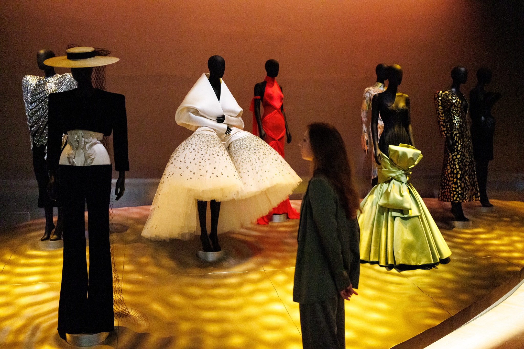 epaselect epa12847423 A gallery staff poses with creations by Italian fashion designer Elsa Schiaparelli during a press preview for the upcoming exhibition 'Schiaparelli: Fashion Becomes Art' at Victoria and Albert Museum in London, Britain, 24 March 2026. The first-ever UK exhibition that explores Schiaparelli's work from the 1920s to today, celebrating the innovative designer's influence and her surrealist legacy, will run from 28 March until November 2026. EPA/TOLGA AKMEN